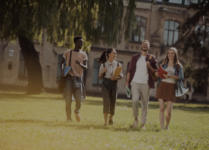 college students walking on campus together on sunny day